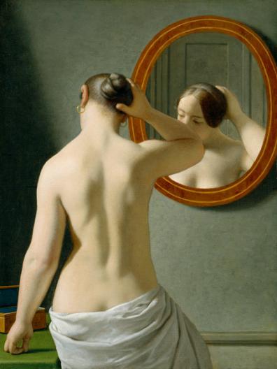 Woman Standing in front of a Mirror