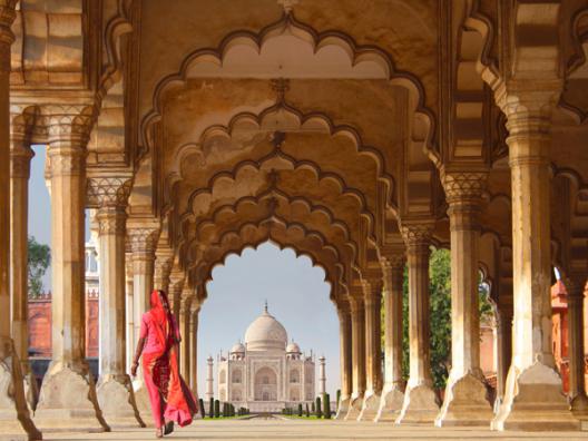 Woman in traditional Sari walking towards Taj Mahal