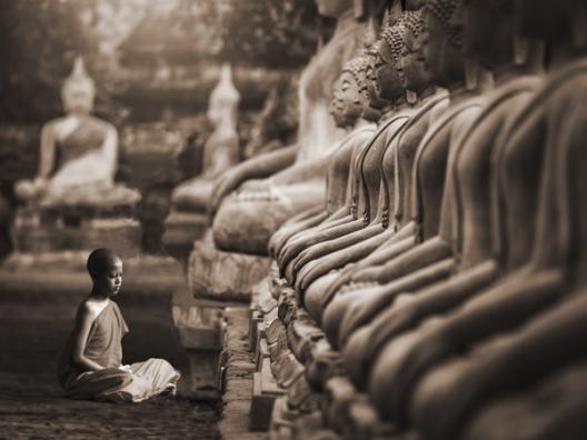 Young Buddhist Monk praying, Thailand (sepia)